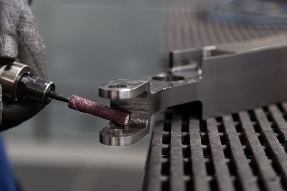 Deburring an aircraft component with a Cibo abrasive